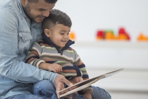 Father Reading His Son a Book