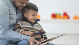 Man with child reading a book