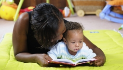 Woman with child reading a book